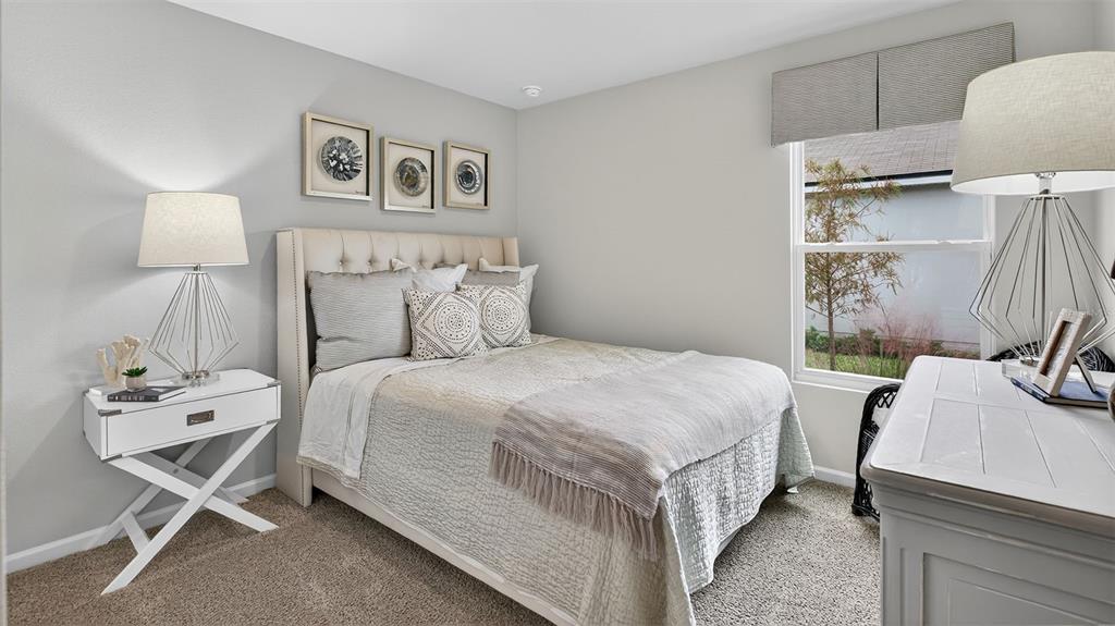 34 Divot Place Bunnell, FL 32110 - Photo 16 of 51 a bedroom with a bed and a table in it