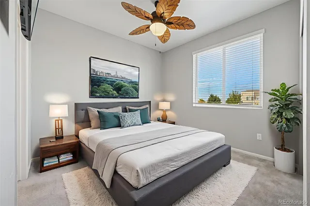 a bedroom with a bed and a potted plant