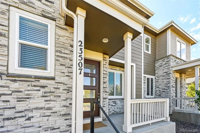 a view of a brick house with large windows