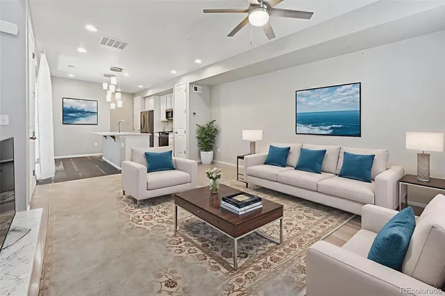 a living room with furniture a rug and a chandelier