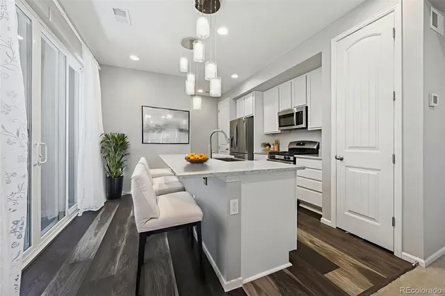 a kitchen with cabinets a sink and appliances