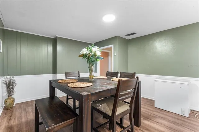 a view of a dining room with furniture and wooden floor