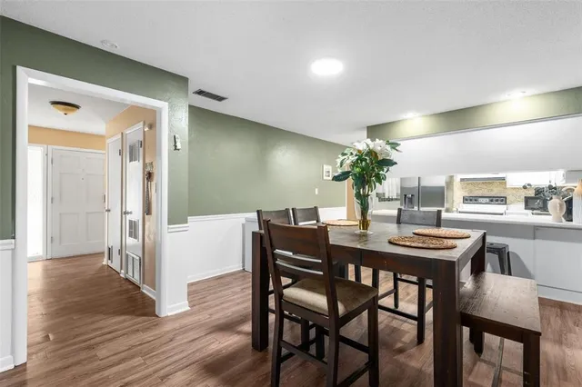 a view of a dining room with furniture and wooden floor