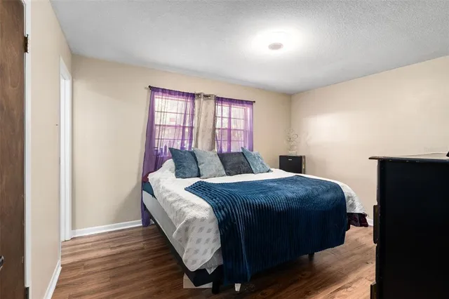 a bed sitting in a bedroom next to a window