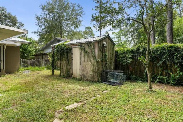 a view of a backyard with a tree