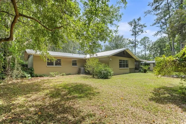 a front view of house with yard and trees