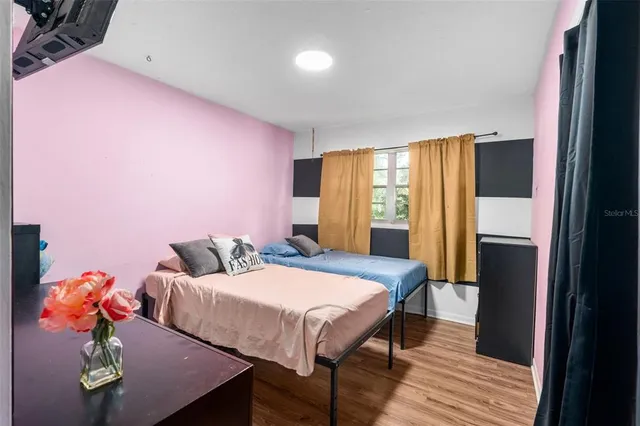 a bedroom with a bed and a window