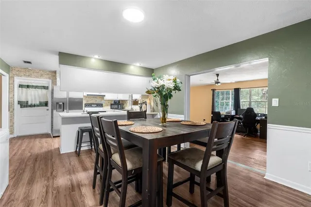 a dining room with furniture and window