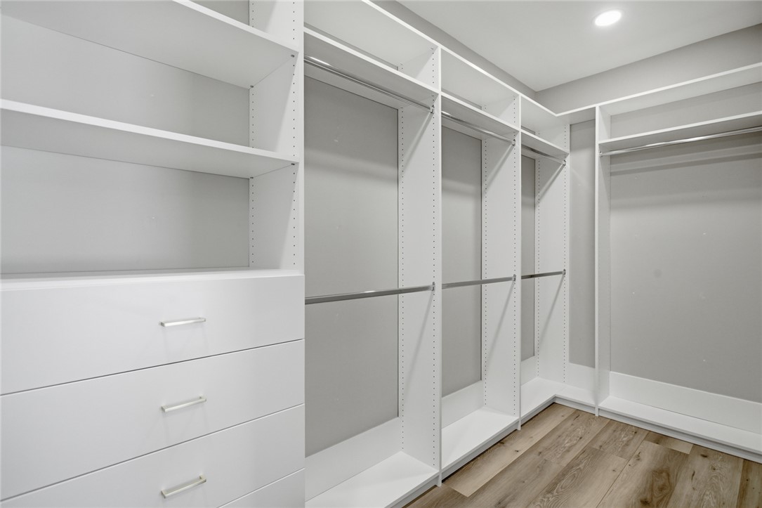 147 McAlister Road West Union, SC 29696 - Photo 17 of 49 This spacious walk-in closet features ample storage with built-in shelving and hardwood flooring.