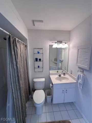 a spacious bathroom with a toilet sink and mirror