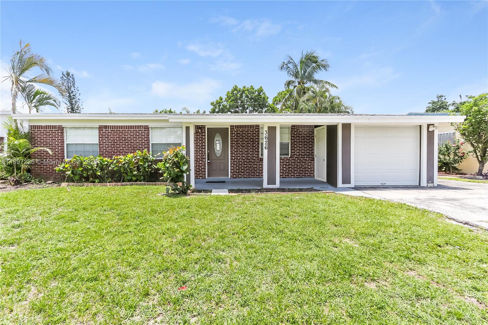 3626 Everglades Road Palm Beach Gardens, FL 33410 - Photo 1 of 16 front view of house with a yard