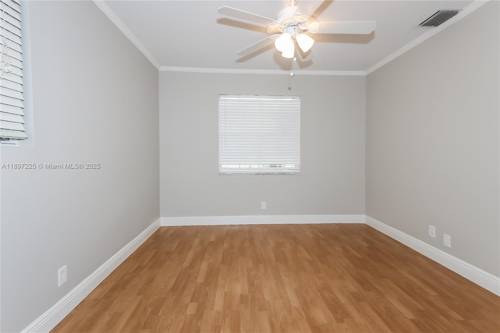 3626 Everglades Road Palm Beach Gardens, FL 33410 - Photo 12 of 16 an empty room with a window and a fan