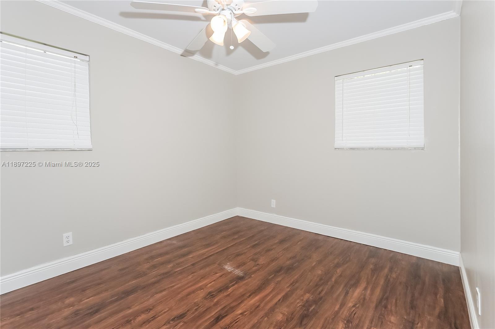 3626 Everglades Road Palm Beach Gardens, FL 33410 - Photo 8 of 16 an empty room with wooden floor and fan