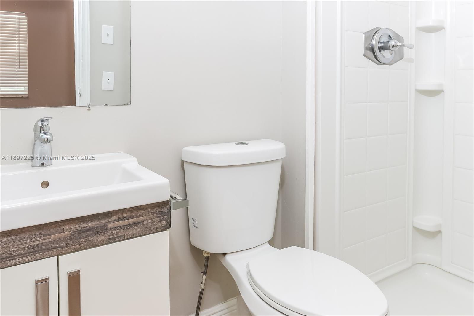 3626 Everglades Road Palm Beach Gardens, FL 33410 - Photo 10 of 16 a white toilet sitting next to a bathroom sink
