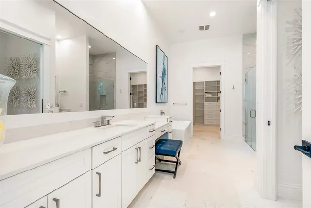 a spacious bathroom with a granite countertop sink mirror and a