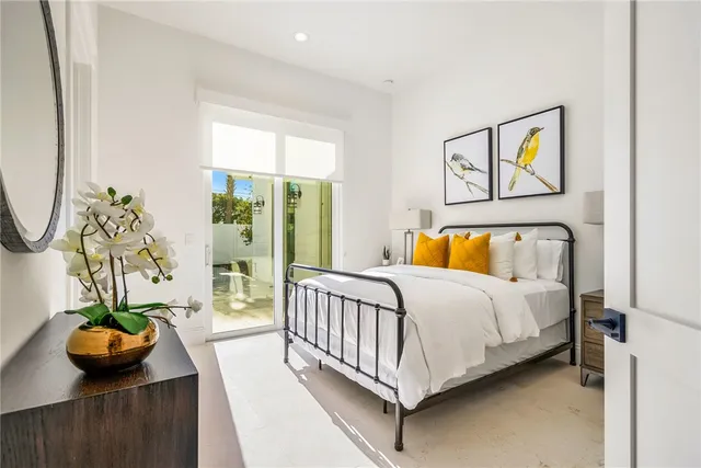 a bed sitting in a bedroom next to a window