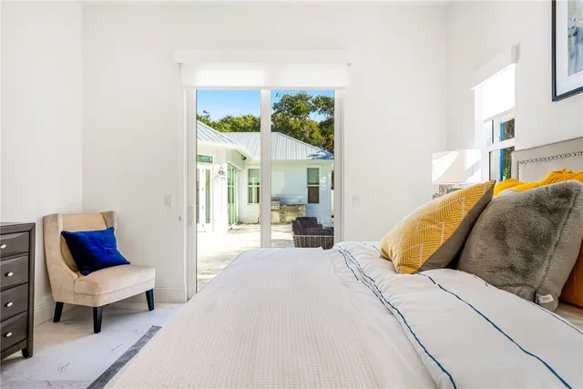 a bed room with a bed and a chair