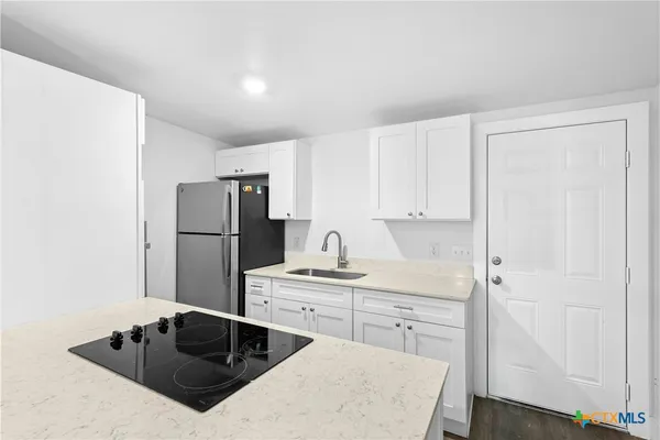 a kitchen with a sink a stove and refrigerator