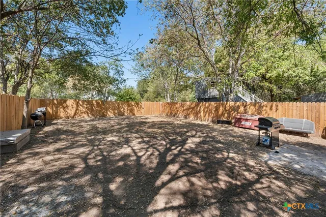 a backyard of a house with table and chairs