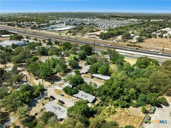 an aerial view of residential houses with outdoor space