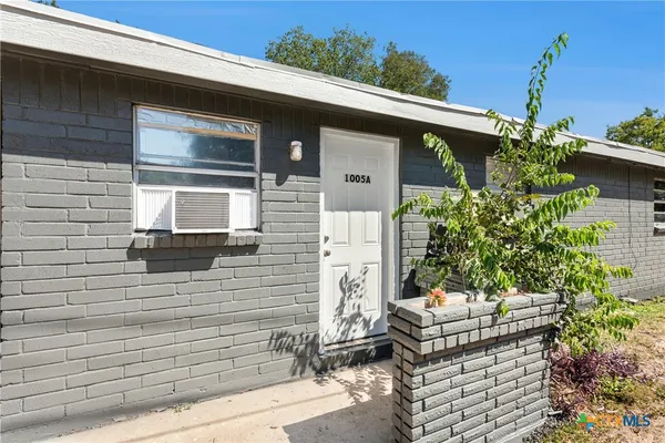 a front view of a house with outdoor seating and plants