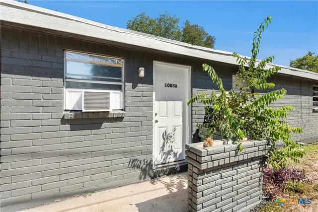 a front view of a house with outdoor seating and plants