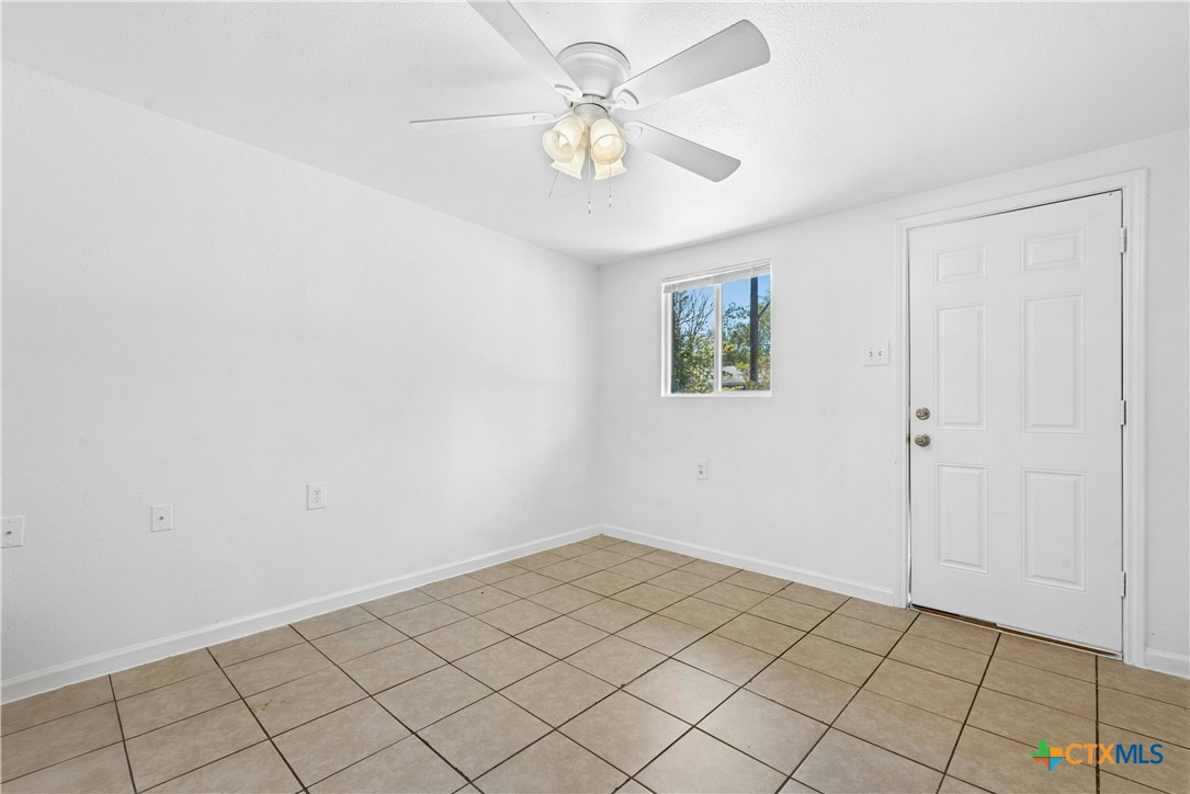 1007 Hackberry Street San Marcos, TX 78666 - Photo 7 of 36 wooden floor in an empty room with a window