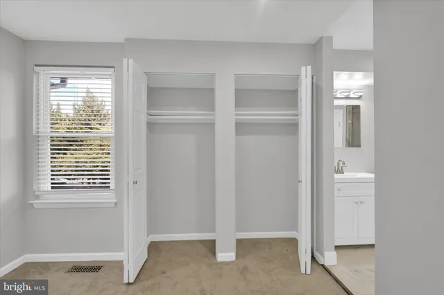 a bathroom with a shower sink and mirror