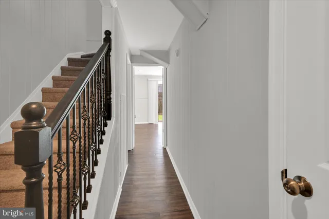 a view of a livingroom with wooden floor and a sink