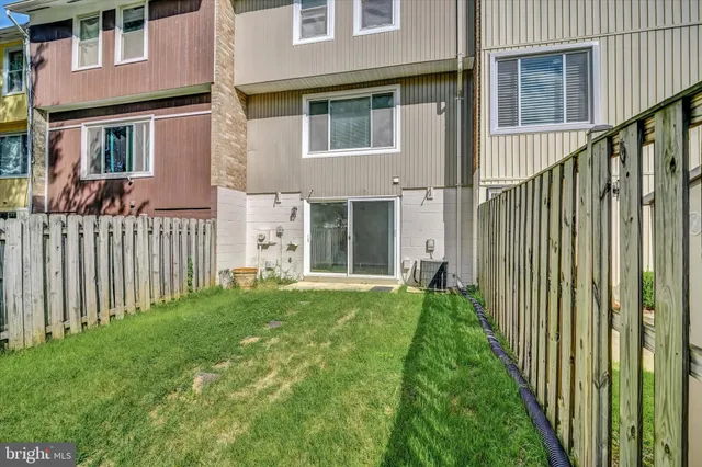 a view of a house with backyard and porch