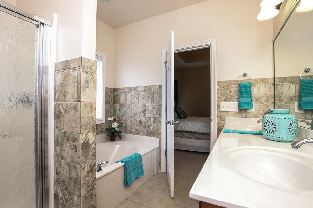 605 Lee Road Lebanon, TN 37087 - Photo 12 of 30 a en suite bathroom with a granite countertop shower and a sink