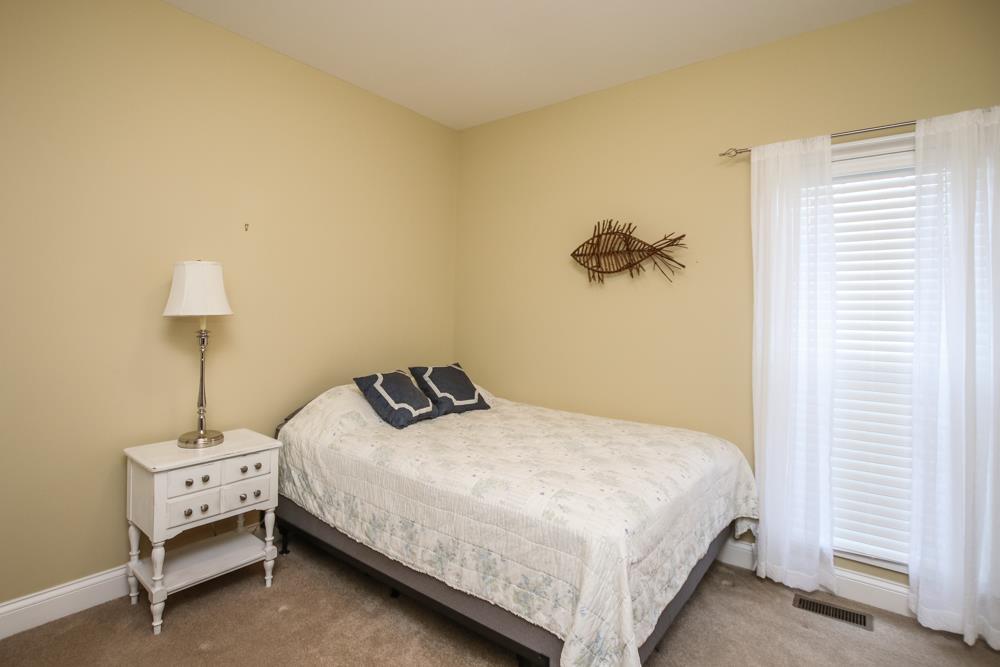 605 Lee Road Lebanon, TN 37087 - Photo 16 of 30 a bedroom with a bed a lamp and a table