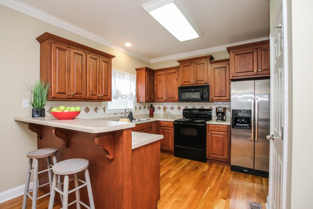 605 Lee Road Lebanon, TN 37087 - Photo 6 of 30 a kitchen with stainless steel appliances granite countertop a sink stove and refrigerator