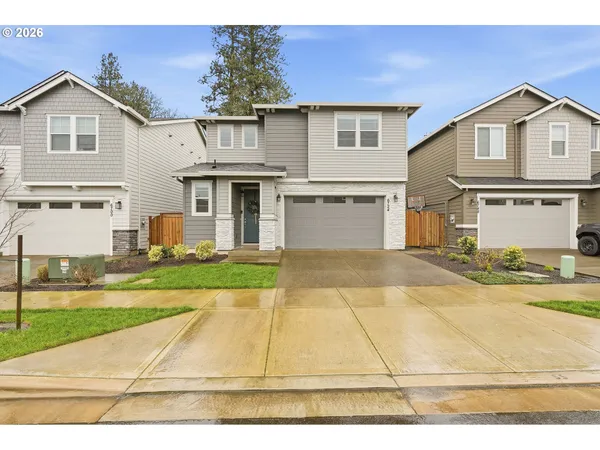 a front view of a house with a yard and garage