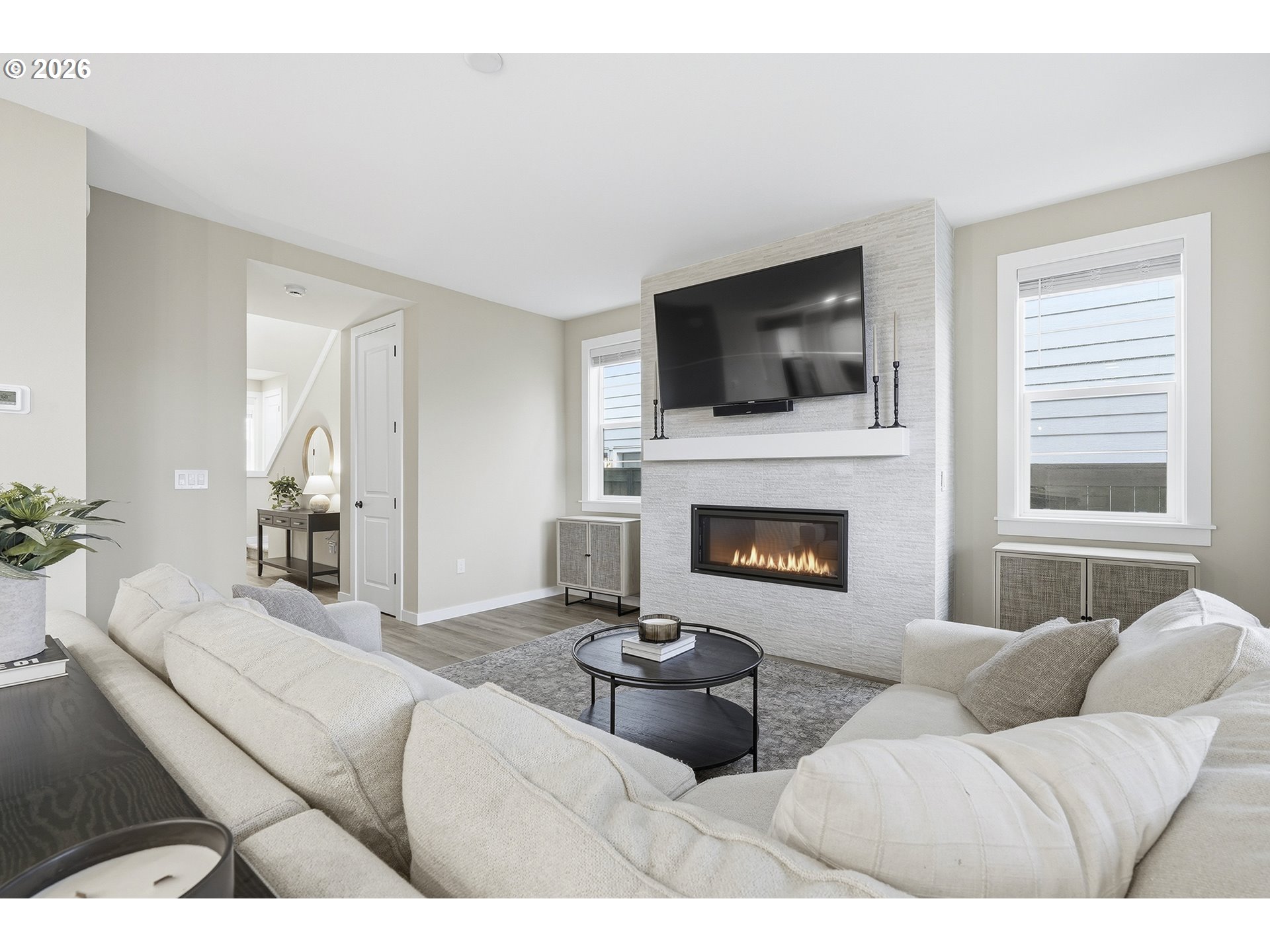 6724 Southwest Lupine Way Wilsonville, OR 97070 - Photo 13 of 45 a living room with furniture a flat screen tv and a fireplace
