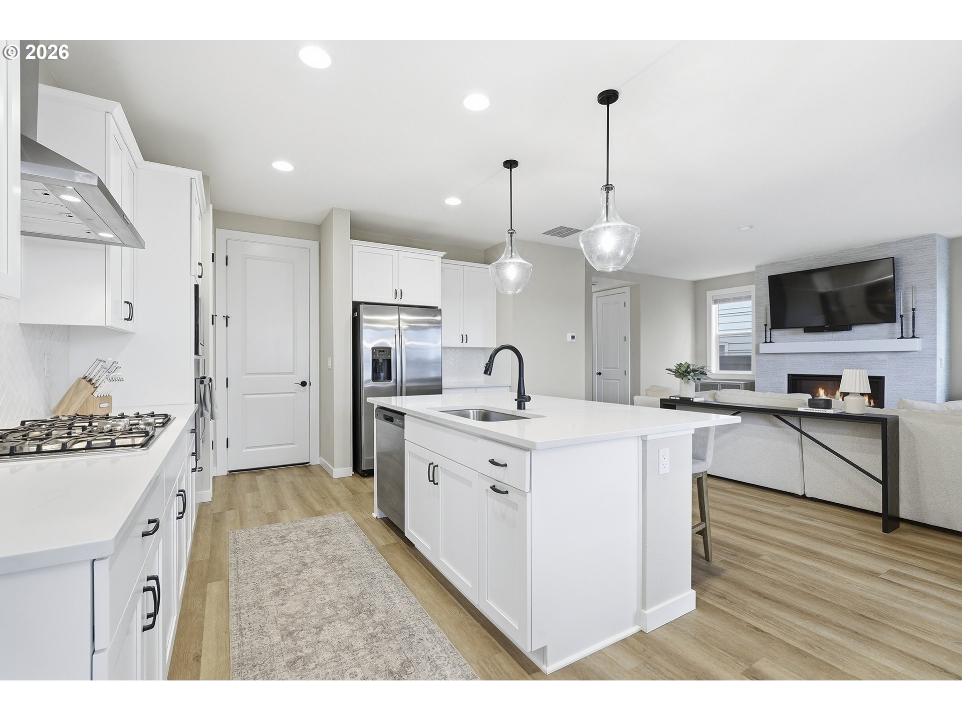 6724 Southwest Lupine Way Wilsonville, OR 97070 - Photo 17 of 45 a large kitchen with stainless steel appliances kitchen island granite countertop a stove a sink a refrigerator and a refrigerator