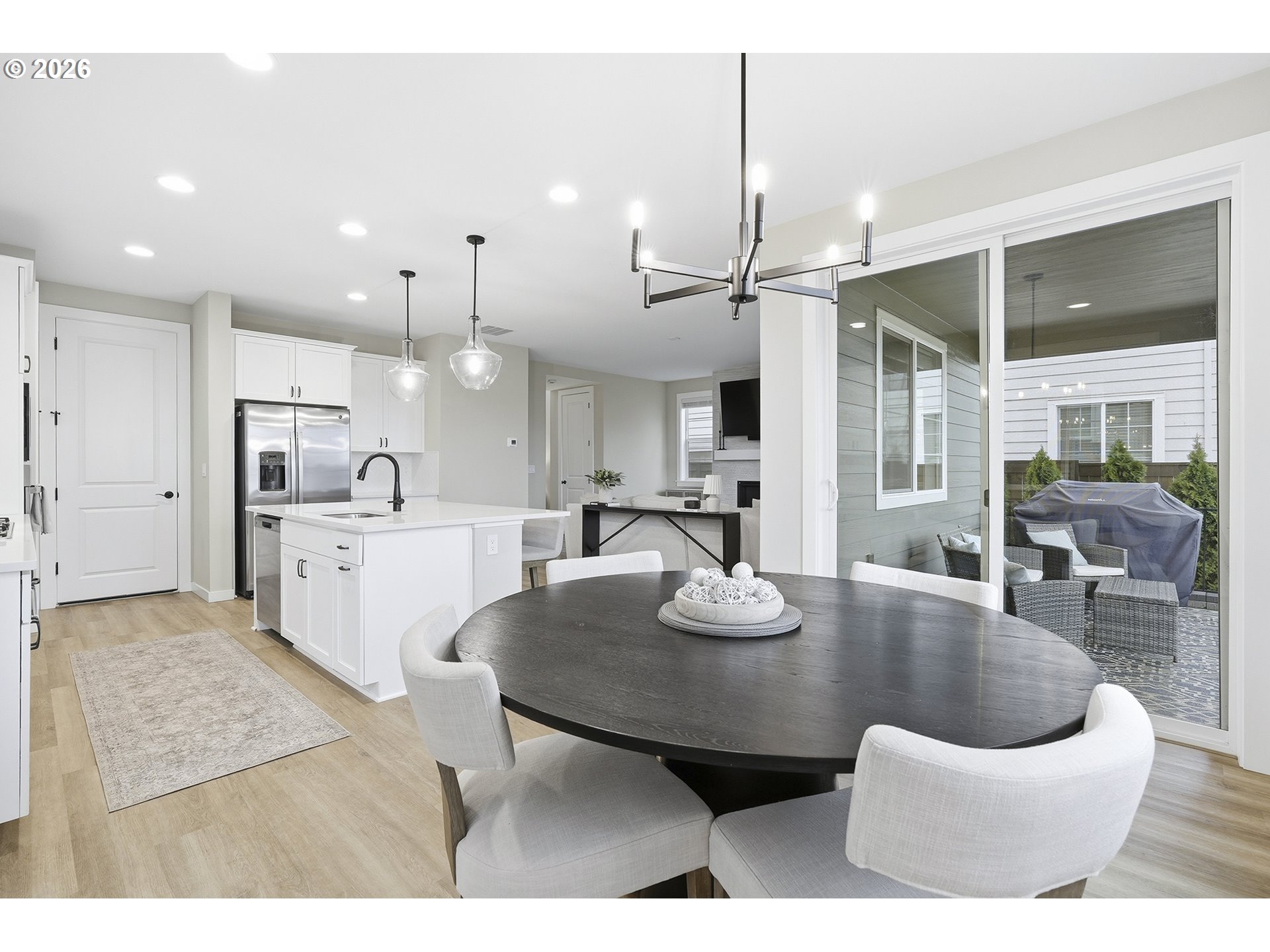 6724 Southwest Lupine Way Wilsonville, OR 97070 - Photo 20 of 45 a kitchen with kitchen island stainless steel appliances a dining table and chairs