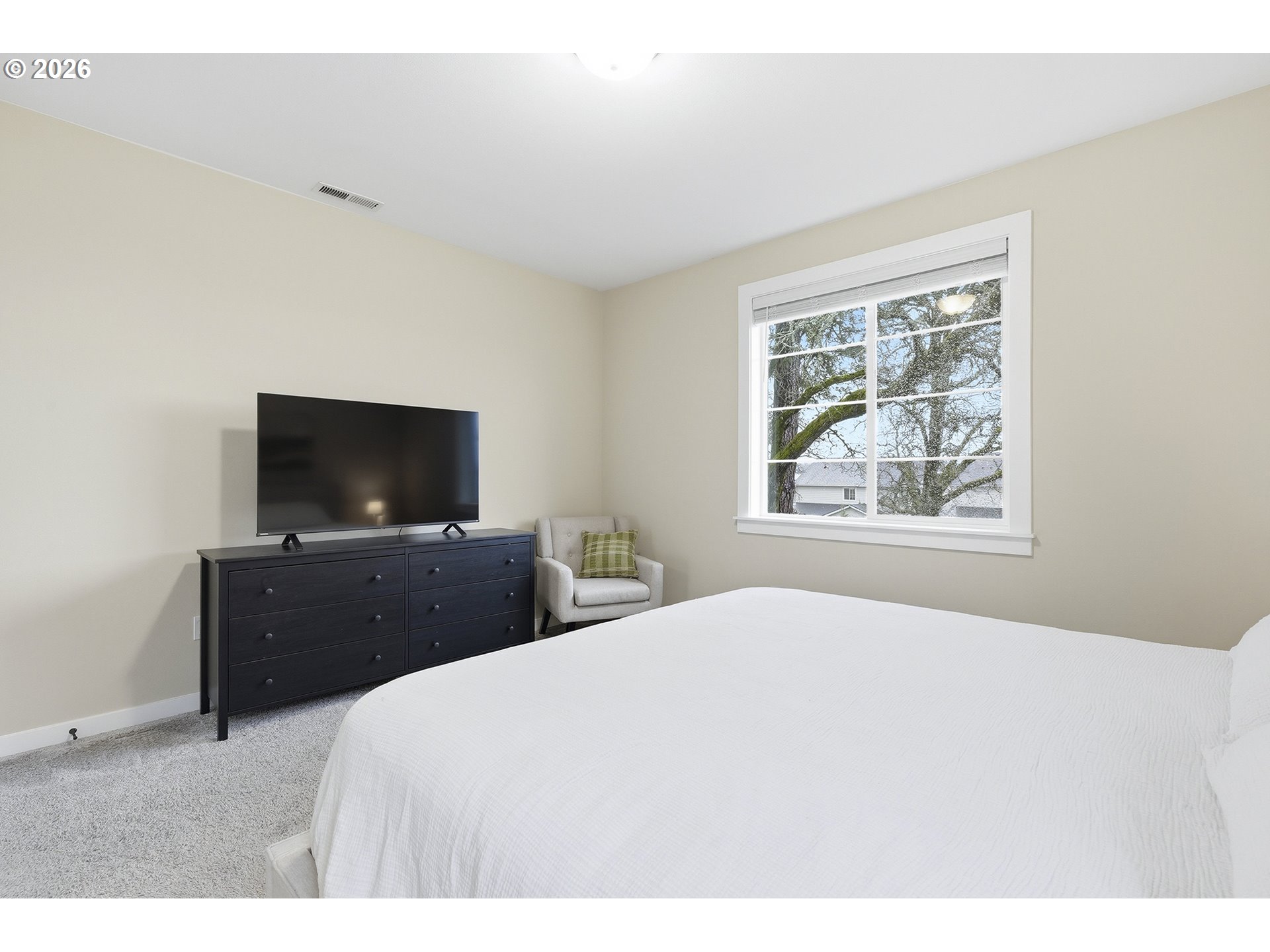 6724 Southwest Lupine Way Wilsonville, OR 97070 - Photo 30 of 45 a bedroom with a bed and a flat screen tv