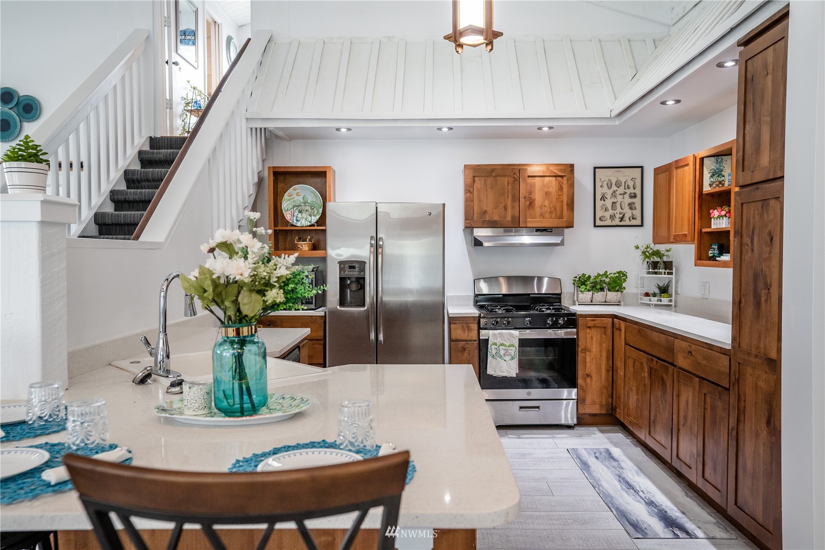3114 Jackson Highway Chehalis, WA 98532 - Photo 19 of 40 a kitchen with stainless steel appliances kitchen island granite countertop a refrigerator a stove a sink dishwasher and white cabinets with wooden floor