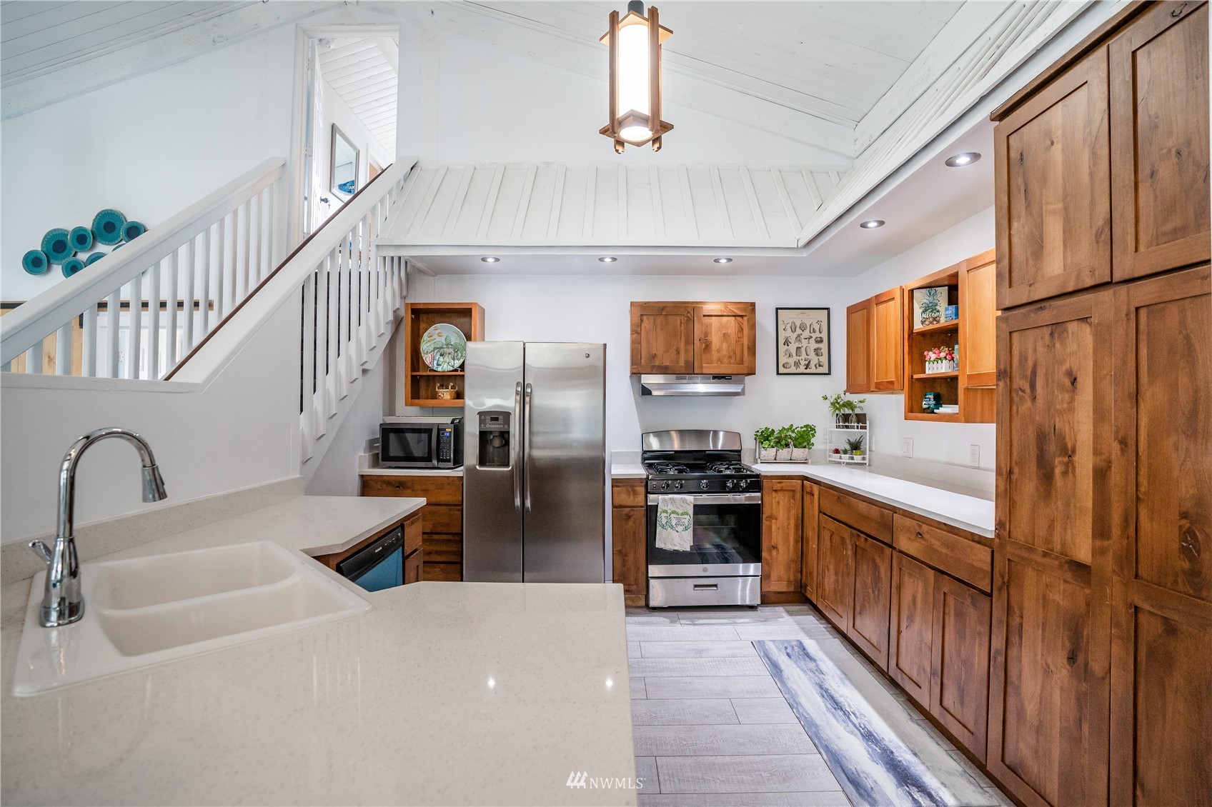 3114 Jackson Highway Chehalis, WA 98532 - Photo 21 of 40 a kitchen with stainless steel appliances granite countertop a refrigerator a stove and a sink with wooden floor