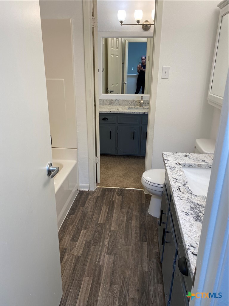 1316 Opal Road, Unit A Killeen, TX 76543 - Photo 13 of 25 a bathroom with a granite countertop sink toilet and shower