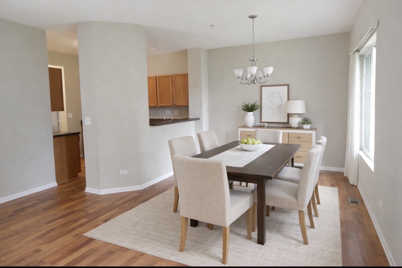 596 Foxridge Drive Fox Lake, IL 60020 - Photo 3 of 9 a dining room with furniture a chandelier and wooden floor