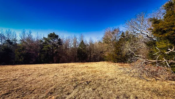 a view of white house with a yard