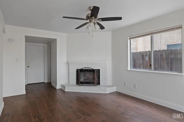 a view of a livingroom with a fireplace and window