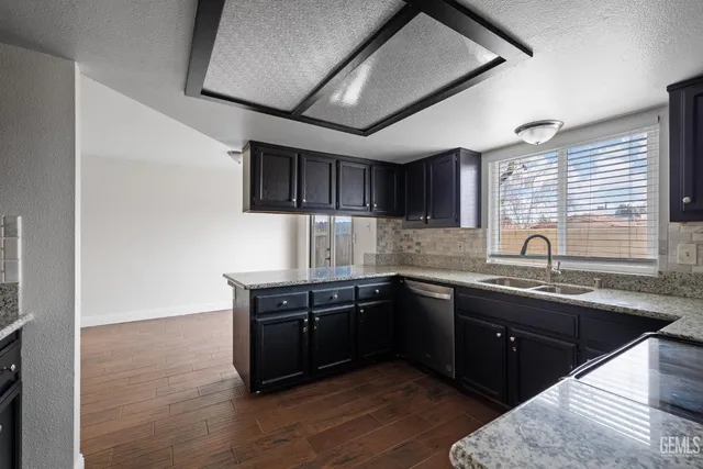 a kitchen with sink and cabinets