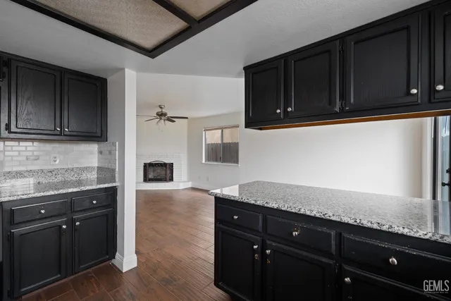 a kitchen with granite countertop stainless steel appliances and wooden cabinets
