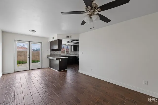 a large kitchen with cabinets wooden floor and stainless steel appliances