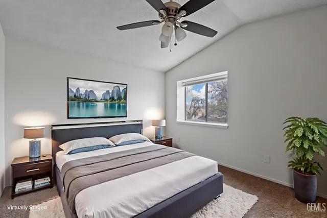 a bedroom with a large bed and a window