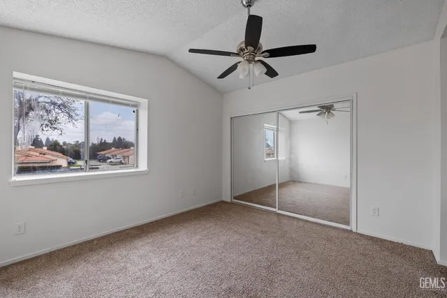 a view of an empty room with a fan