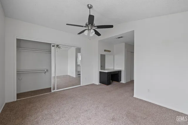 a view of a room with a ceiling fan